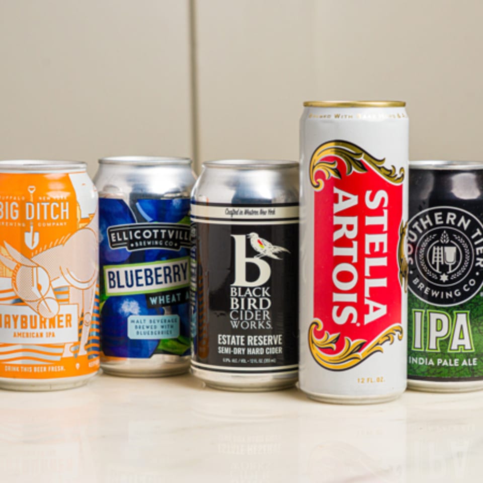 Five assorted beer and cider cans, including Stella Artois, Big Ditch, and Black Bird Cider Works.