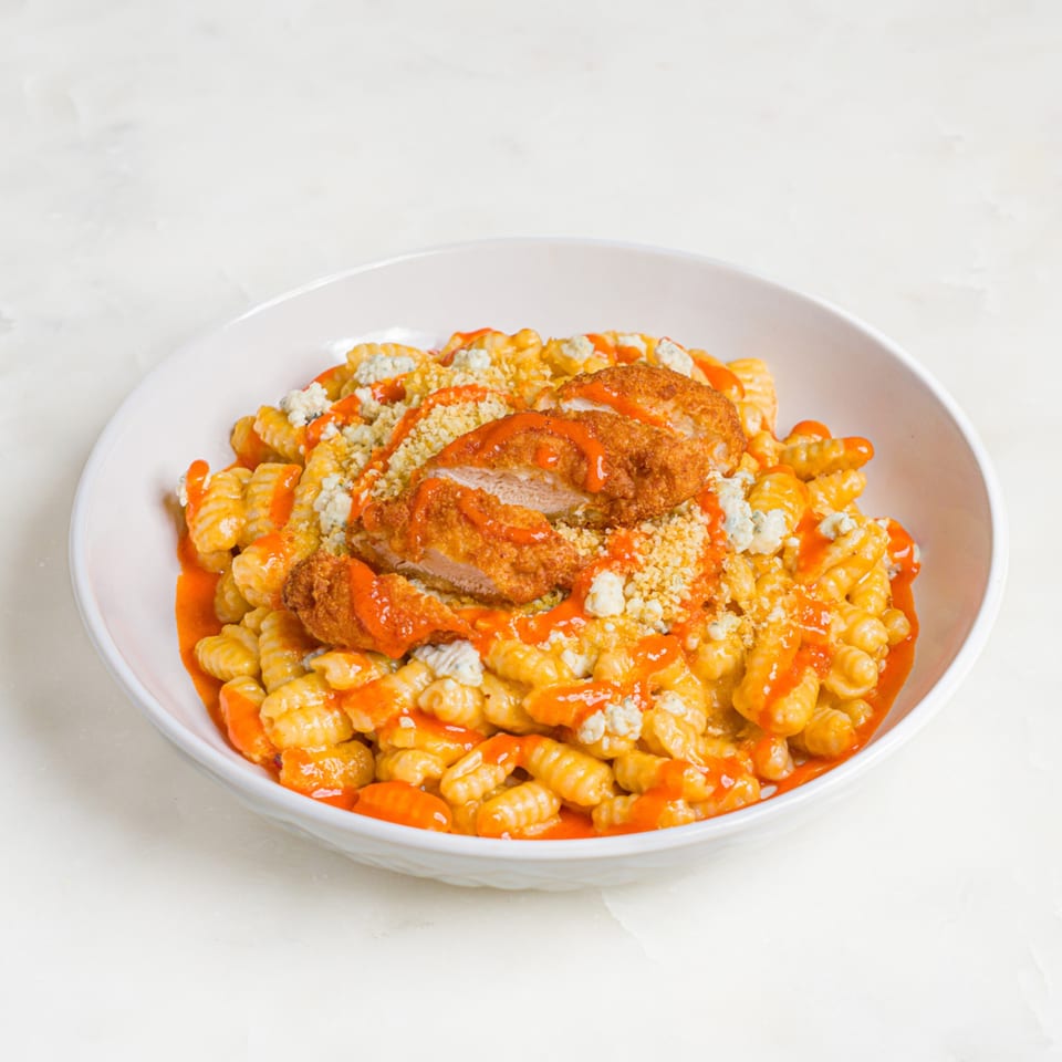 A'mano Fresh Pasta Kitchen's buffalo chicken gnocchi with blue cheese crumbles and hot sauce.